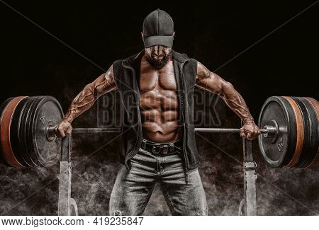 Muscular Bearded Man Stands Near The Barbell. Bodybuilding, Fitness, Powerlifting Concept.