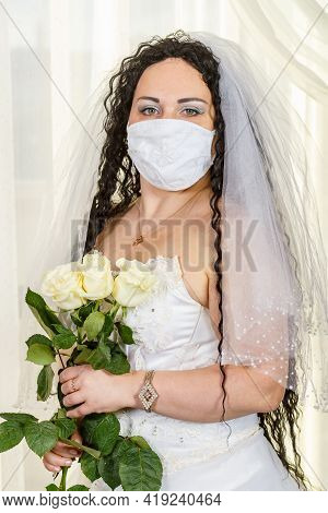 A Jewish Bride In A Synagogue Before A Chuppa Ceremony During A Pandemic, Wearing A Medical Mask And