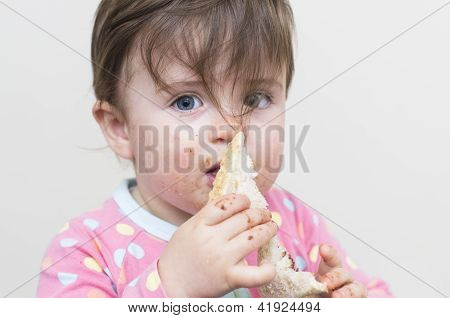 Very Messy Girl Eating A Sandwich