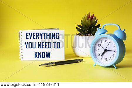 Everything You Need To Know. Motivational Quote Is Written On A Notebook, Next To A Cactus, An Alarm