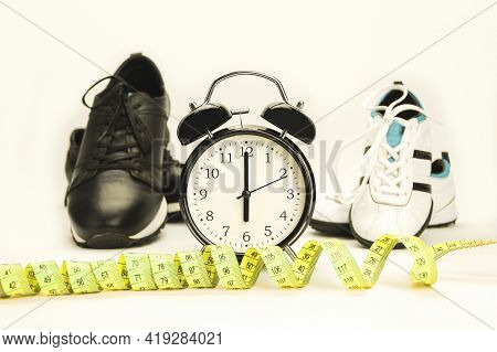 Watch And Sneakers Close Up - Fitness Concept. At The Alarm Clock 6.00. Time To Run. Healthy Lifesty