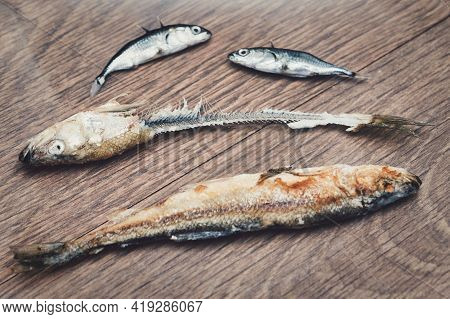 Whole Fried Fish Smelt And Fish Bones On A Plate.