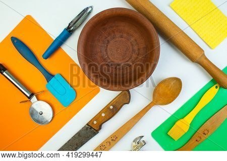 Background Of Kitchen Utensils On White Wooden Kitchen Table. Tools. Top View.