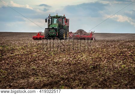 Baykivtsi, Ternopil Region, Ukraine - April 20, 2021: Farmers Sow, Apply Fertilizer Using A John Dee