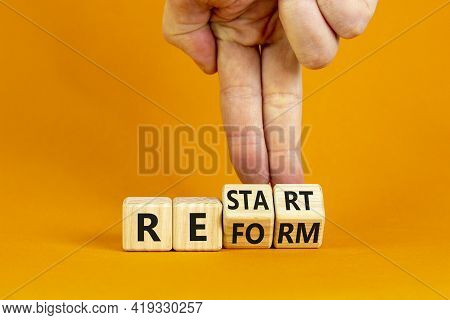 Restart And Reform Symbol. Businessman Turns Cubes And Changes The Word 'restart' To 'reform'. Beaut