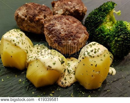 Fried Meatballs With Boiled Broccoli And Parsley Potatoes
