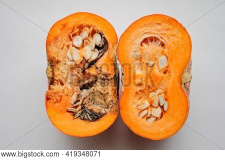A Pumpkin Cut In Half, Left Half Is Rotten, Right Half - Good Quality, On A White Background.