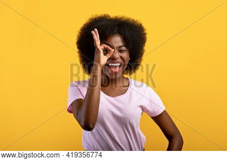 All Is Ok. Positive African American Lady Looking Through Okay Sign, Covering One Eye With Okey Gest