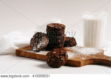 Tasty Homemade Gingerbread Cookies And Glass Of Milk On White Table