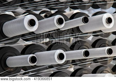 Coils Of White Flat Polypropylene Yarn For The Production Of Industrial Bags. Circular Loom Woven Ba