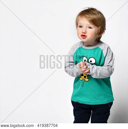 Little Smiling Preschool Toddler Boy European Ethnicity Wearing Trendy Green Raglan With Cute Muzzle