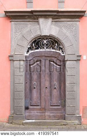 Beautiful Front Door. Carved Door With Metal Forging. Entrance To One Of The Old Houses In Barga.