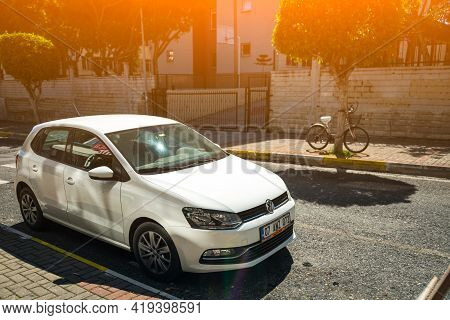 Alanya, Turkey - April 17 2021:  White Ford Golf      Is Parked  On The Street On A Warm Summer Day 