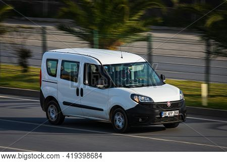 Alanya, Turkey  - April 17  2021:    White Fiat Duplo   Is Driving Fast On The Street On A Warm Summ