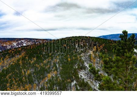 Mountain In The Autumn Forest With Trees With A Stone Rock At The Top.