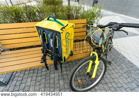 Kiev, Ukraine - April 28, 2021: Glovo Bike Courier On The Street. Delivery Boy Of Glovo Delivery Ser