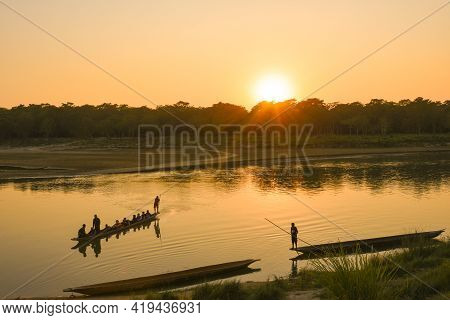 Sunset In The River And Boats Man
