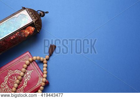 Arabic Lantern, Quran And Misbaha On Blue Background, Flat Lay. Space For Text