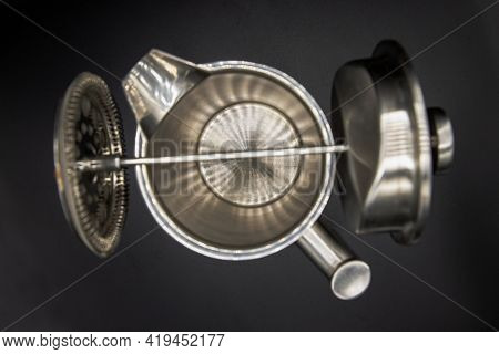 Top View Of Cafetiere Plunger Is Placed On Stainless Steel Jug With Black Background. French Press C