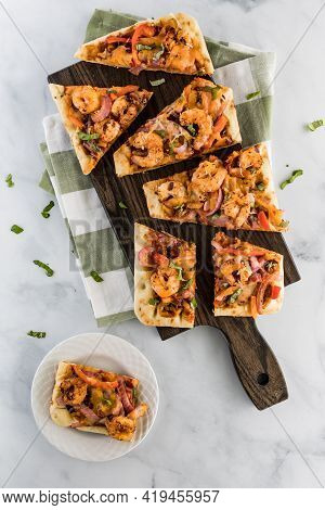 Applewood Smokey Bbq Shrimp Flatbread Pizza On A Cutting Board Ready For Eating.