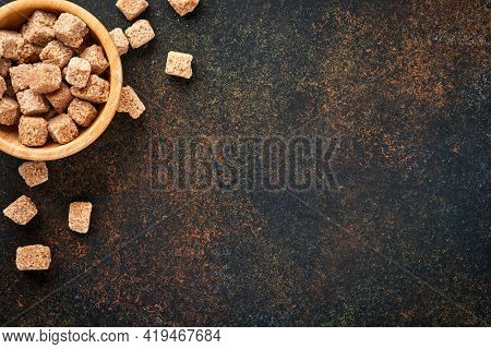 White Sugar, Cane Sugar Cubes, Caramel In Bamboo Bowl On Dark Brown Table Concrete Background. Assor