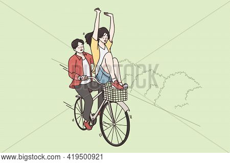 Riding Bicycle And Street Summer Activities Concept. Smiling Happy Couple Riding Fixed Gear Bicycle 
