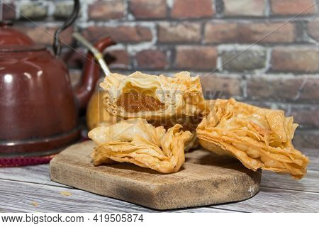 Plate Of Fried Sweet Potato And Quince Pastries. Traditional In The Argentine National Holidays
