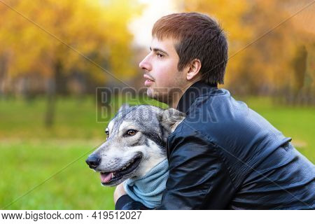 Young Happy Man Hugging Dog. Pet Adoption.  Czechoslovak With Male Owner. Boy Walking, Playing, Trai