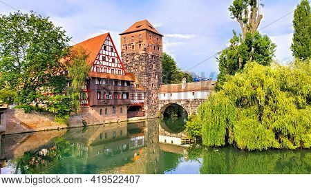Nuremberg, Germany, Beautiful Old Bridge With Medieval Tower And Half Timbered House Along The River