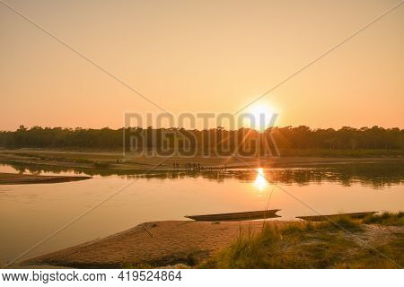 Sunset On The River And Empty Boat
