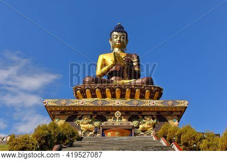 The statue of Buddha at the Buddha park with blue sky and clouds in the background as seen from Rabo