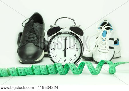 Watch And Sneakers Close Up - Fitness Concept. At The Alarm Clock 6.00. Time To Run. Healthy Lifesty