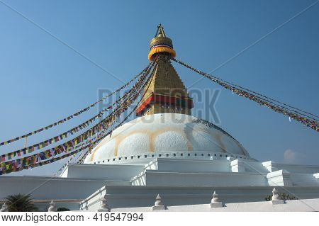 Big Old White Buddhist Stupa And Prayer Flags