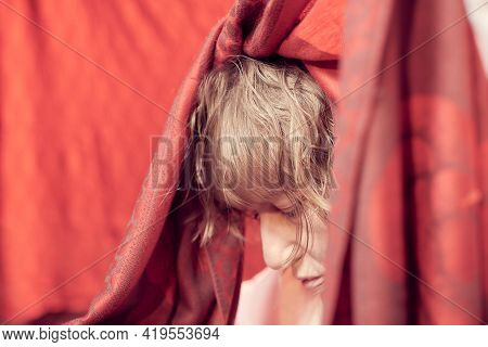 Portrait Of Sad Middle-aged Woman With Red Scarf On A Red Background. Unprofessional Female Model Cl