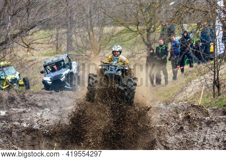 Afipsip, Russia - October 31, 2020: Sportsman On Quad Bike Drives Splashing In Dirt And Water At Mud