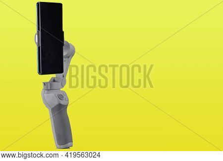 Image Stabilizer Gimbal For Modern Cell Phones. Instrument For Amateur Filming. Image And Video Stab