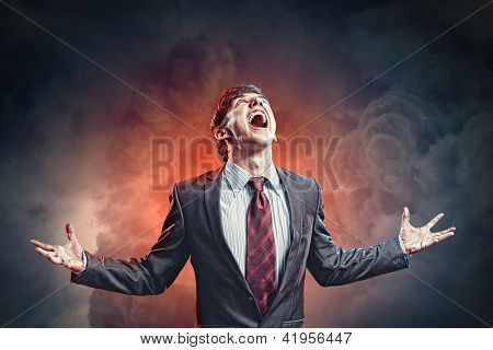 businessman in anger with fists clenched screaming