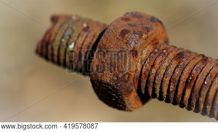 Rusty Nut. Rusty Iron Rod With Screw Threads. Rusted Mechanical Components. Threaded Bolt And Nut Is