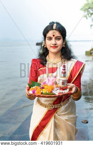 Portrait Of Beautiful Indian Girl In Front Of Ganga River Wearing Traditional Indian Saree, Gold Jew