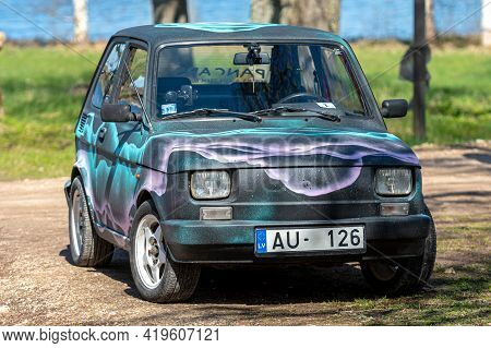 Koknese, Latvia - May 01, 2021: Colorful Oldtimer Pancars Rental Car Fiat 126 Parked On The Side Of 