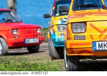 Koknese, Latvia - May 01, 2021: Several Colorful Oldtimer Pancars Rental Cars Fiat 126 Parked On The