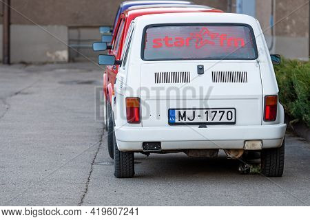 Madona, Latvia - May 01, 2021: Several Colorful Oldtimer Rental Cars Fiat 126 Parked In The Yard