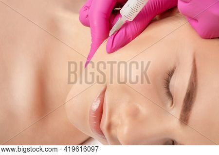 Cosmetologist Makes Lipolytic Injections To Burn Fat On The Chin, Cheeks And Neck Of A Woman Against