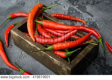 Chili Spur Pepper  Set, In Wooden Box, On Gray Stone Background
