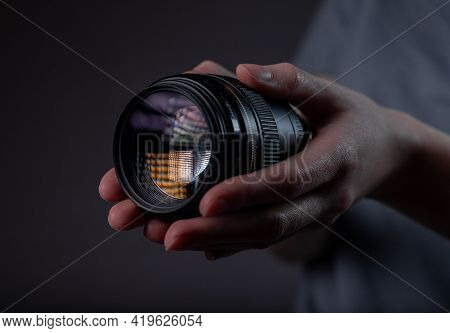 Modern Digital Camera Lens 85 Mm In Hand Over Dark Black Gray Background