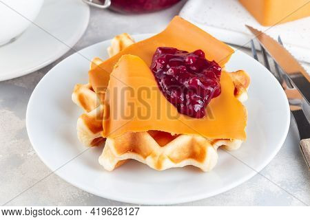 Homemade Waffles With Norwegian Brown Cheese And Lingon Jam, On A Gray Background, Horizontal