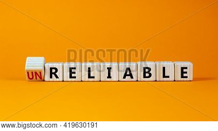 Unreliable Or Reliable Symbol. Turned Wooden Cubes And Changed The Word Unreliable To Reliable. Beau
