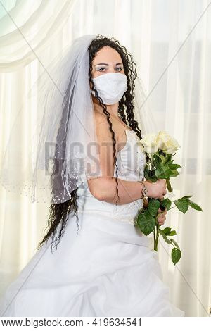 A Jewish Bride In A Synagogue Before A Chuppa Ceremony During A Pandemic, Wearing A Medical Mask And