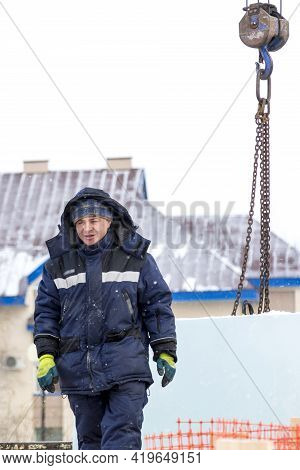 A Portrait Of A Fitter In A Blue Jacket At The Hook