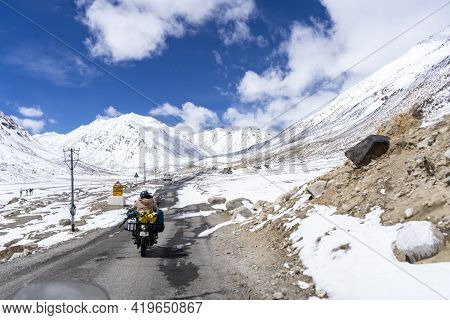 Indian Biker Riding A Bike Through The World Highest Motorable Road Khardungla Pass In Ladakh.